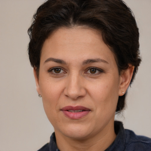 Joyful white adult female with short  brown hair and brown eyes