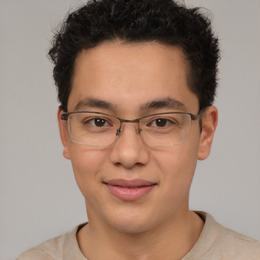 Joyful latino young-adult male with short  brown hair and brown eyes