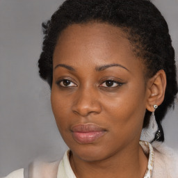 Joyful black young-adult female with medium  brown hair and brown eyes