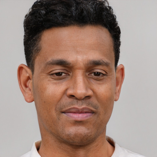 Neutral latino adult male with short  brown hair and brown eyes