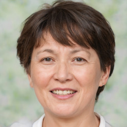 Joyful white adult female with medium  brown hair and brown eyes