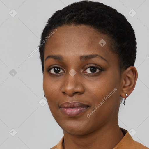 Joyful black young-adult female with short  black hair and brown eyes