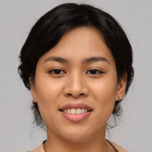 Joyful asian young-adult female with medium  black hair and brown eyes