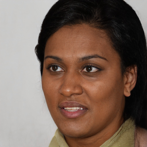 Joyful black adult female with short  brown hair and brown eyes