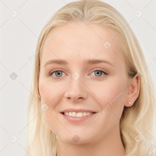 Joyful white young-adult female with long  brown hair and blue eyes