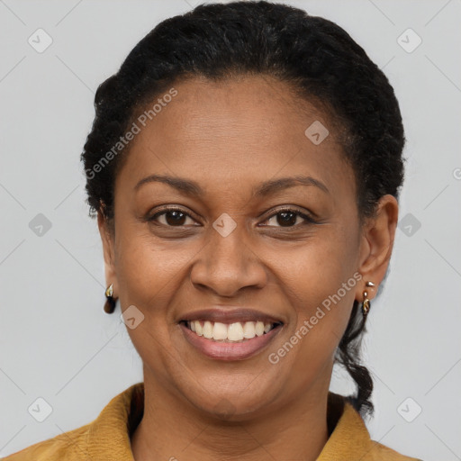 Joyful black adult female with short  brown hair and brown eyes