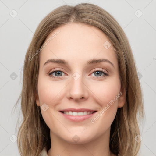 Joyful white young-adult female with long  brown hair and grey eyes