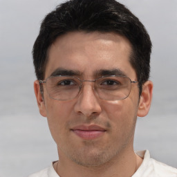 Joyful white adult male with short  black hair and brown eyes