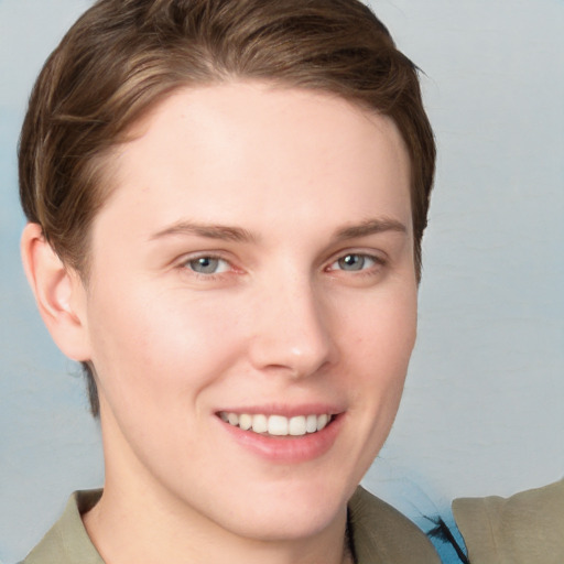 Joyful white young-adult female with short  brown hair and grey eyes