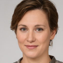 Joyful white adult female with medium  brown hair and grey eyes