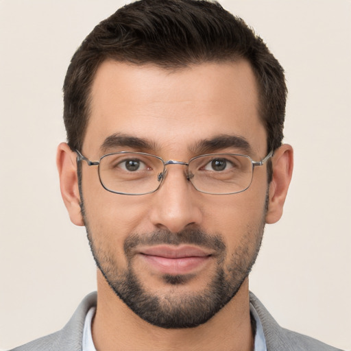 Joyful white young-adult male with short  black hair and brown eyes