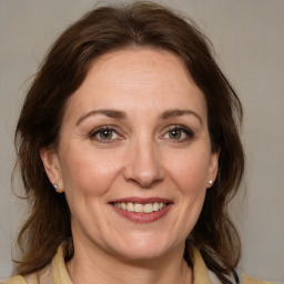 Joyful white adult female with medium  brown hair and grey eyes