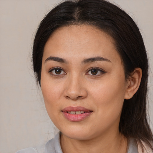 Joyful white young-adult female with medium  brown hair and brown eyes