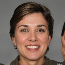 Joyful white adult female with medium  brown hair and brown eyes