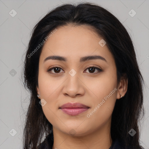 Joyful latino young-adult female with long  brown hair and brown eyes