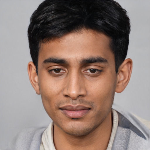 Joyful asian young-adult male with short  black hair and brown eyes