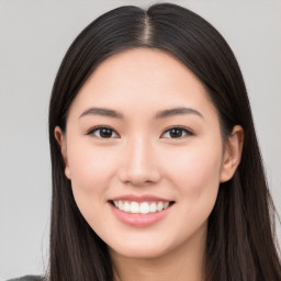 Joyful white young-adult female with long  black hair and brown eyes