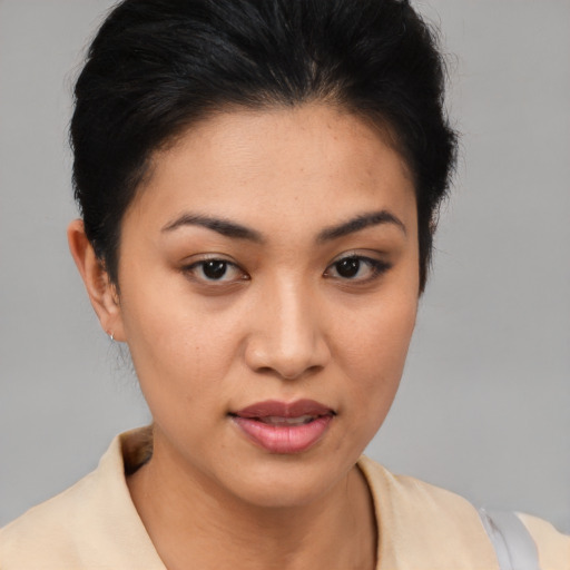 Joyful latino young-adult female with short  brown hair and brown eyes