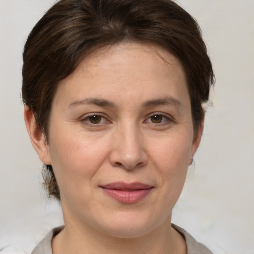 Joyful white young-adult female with medium  brown hair and brown eyes