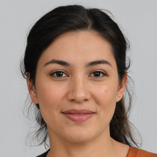 Joyful latino young-adult female with medium  brown hair and brown eyes