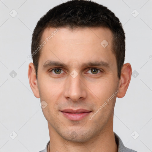 Joyful white young-adult male with short  brown hair and brown eyes