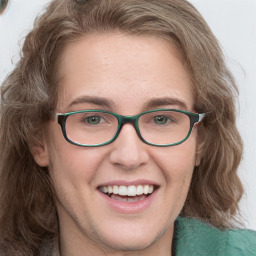 Joyful white young-adult female with medium  brown hair and green eyes