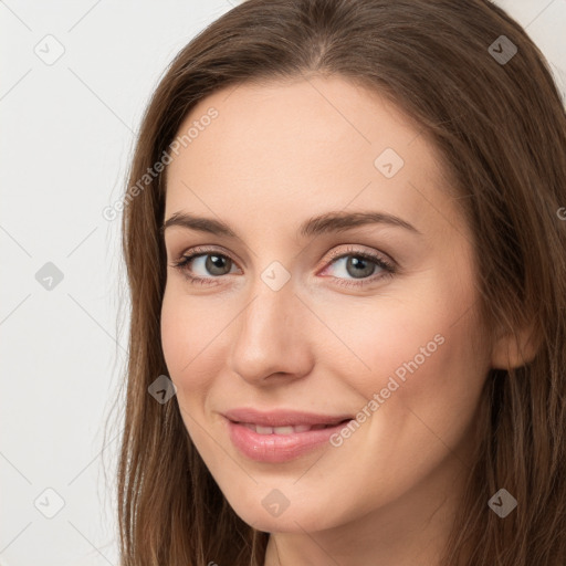 Joyful white young-adult female with long  brown hair and grey eyes