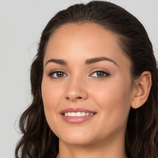 Joyful white young-adult female with long  brown hair and brown eyes