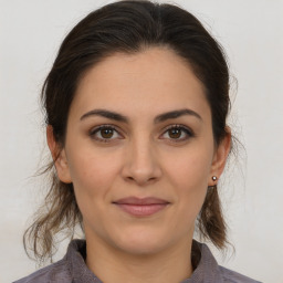 Joyful white young-adult female with medium  brown hair and brown eyes