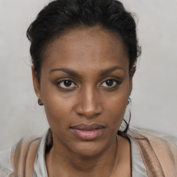 Joyful black young-adult female with short  brown hair and brown eyes