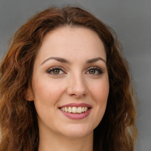 Joyful white young-adult female with long  brown hair and green eyes