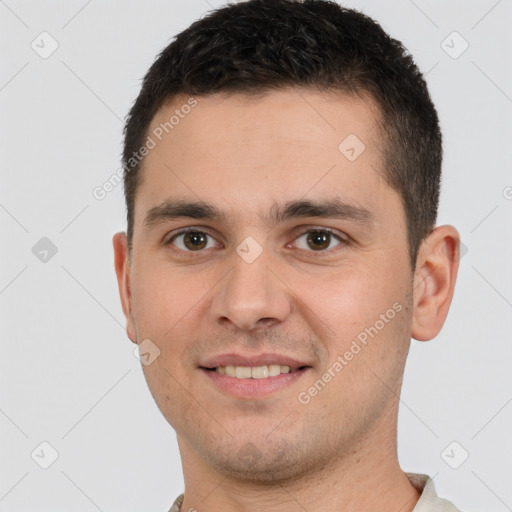 Joyful white young-adult male with short  brown hair and brown eyes