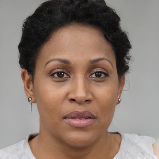 Joyful latino adult female with short  brown hair and brown eyes