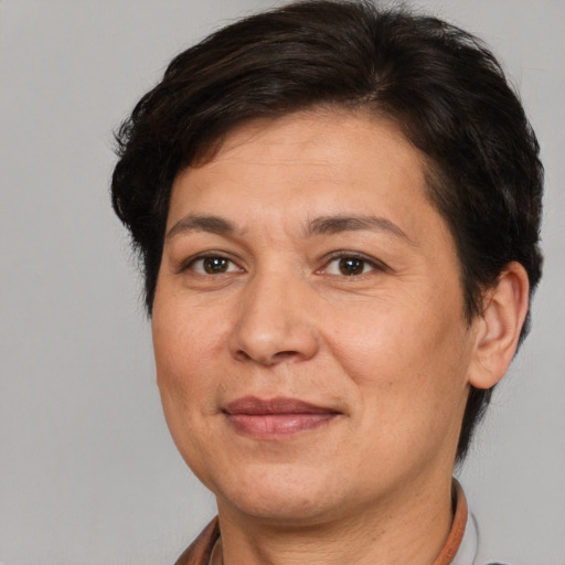 Joyful white adult female with short  brown hair and brown eyes