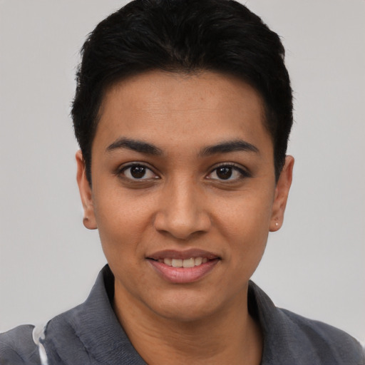 Joyful latino young-adult female with short  black hair and brown eyes