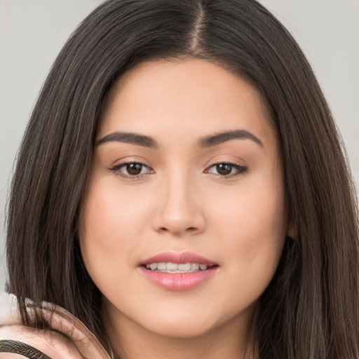 Joyful white young-adult female with long  brown hair and brown eyes