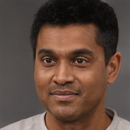 Joyful latino adult male with short  black hair and brown eyes