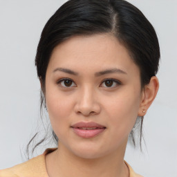 Joyful asian young-adult female with medium  brown hair and brown eyes