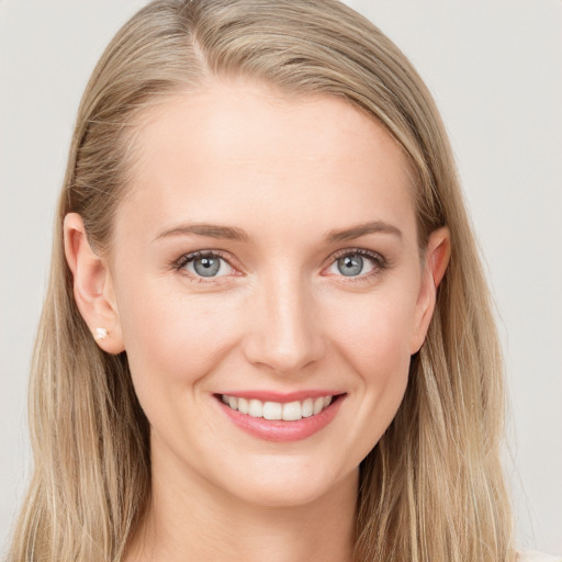 Joyful white young-adult female with long  brown hair and blue eyes