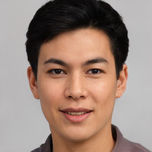 Joyful asian young-adult male with short  black hair and brown eyes