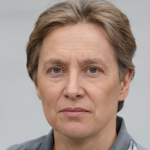 Joyful white middle-aged male with short  brown hair and grey eyes