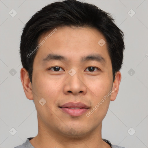 Joyful asian young-adult male with short  brown hair and brown eyes