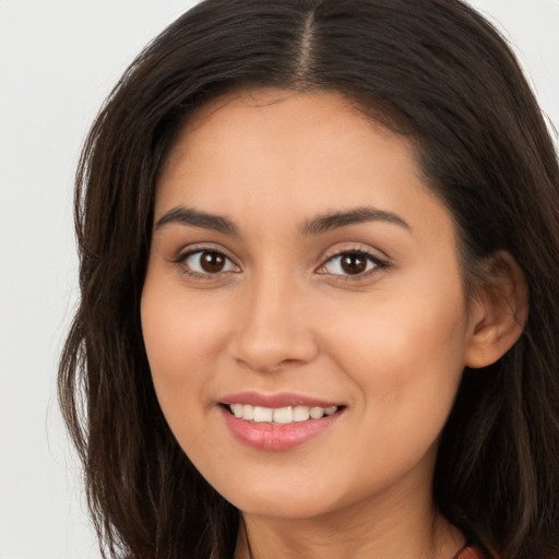 Joyful white young-adult female with long  brown hair and brown eyes