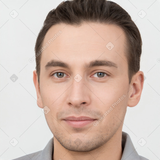 Joyful white young-adult male with short  brown hair and brown eyes