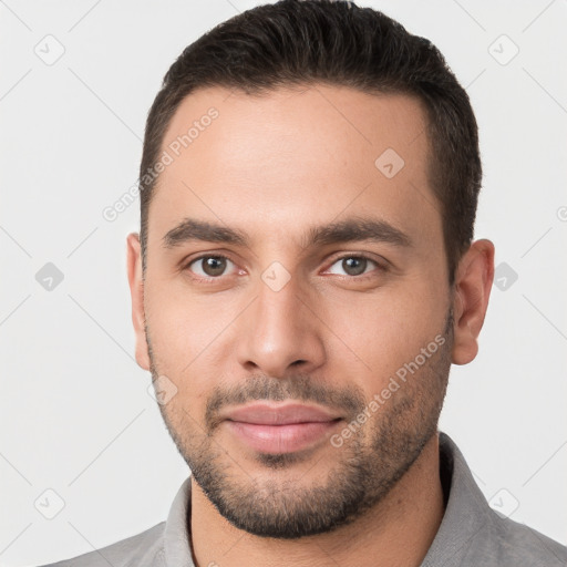 Joyful white young-adult male with short  brown hair and brown eyes