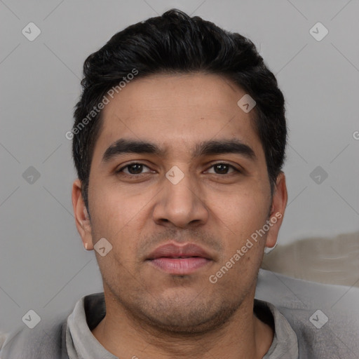 Joyful white young-adult male with short  black hair and brown eyes