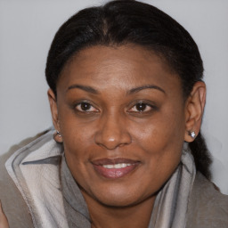 Joyful black adult female with medium  brown hair and brown eyes