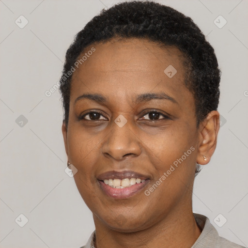 Joyful black adult female with short  black hair and brown eyes