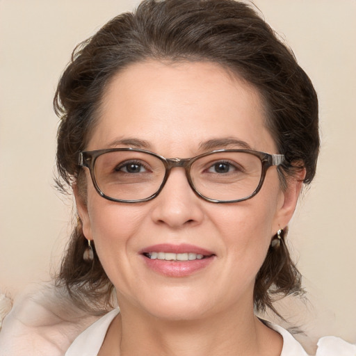 Joyful white adult female with medium  brown hair and brown eyes