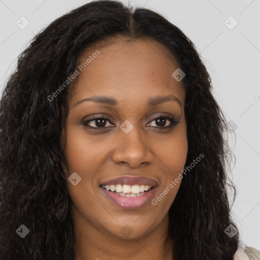 Joyful black young-adult female with long  brown hair and brown eyes